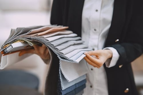 woman-customer-looking-for-beautiful-fabric-in-drapery-shop
